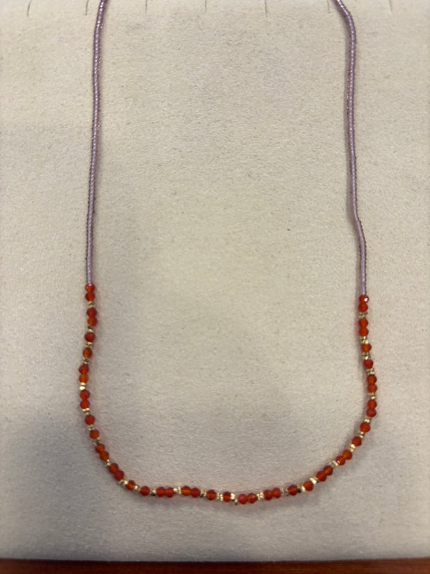 Clear pink seed necklace